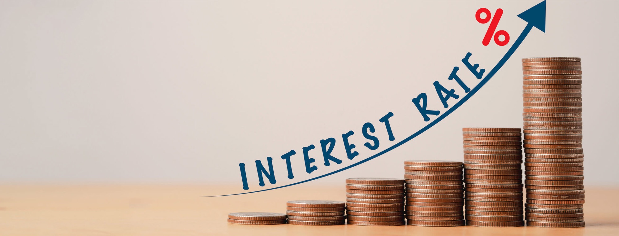 Stacks of coins rising beside the words interest rate