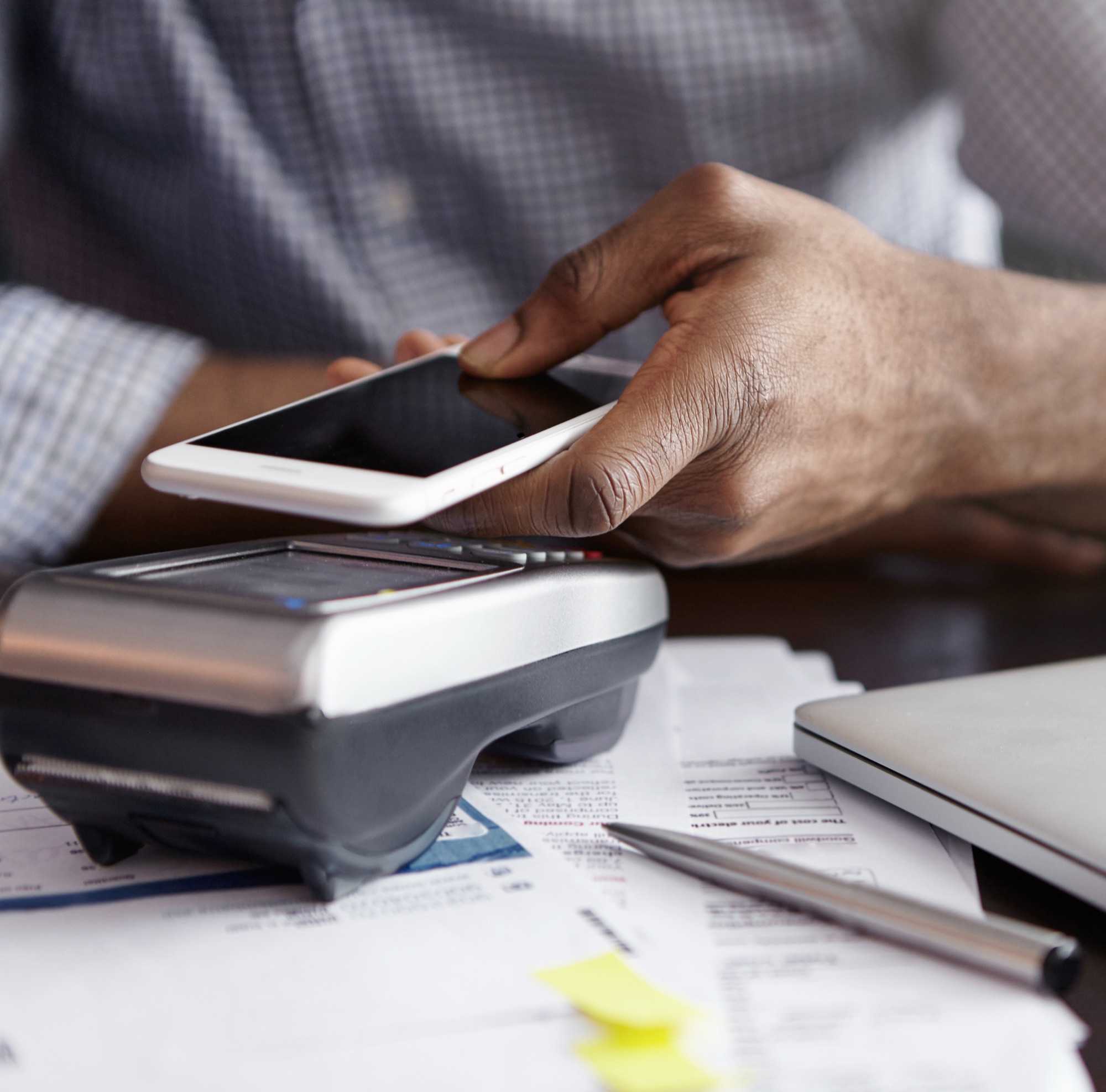 A customer taps a phone on a card payment terminal