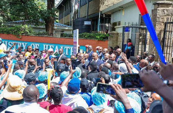 A crowd of health workers gathered outside the Ministry of Health