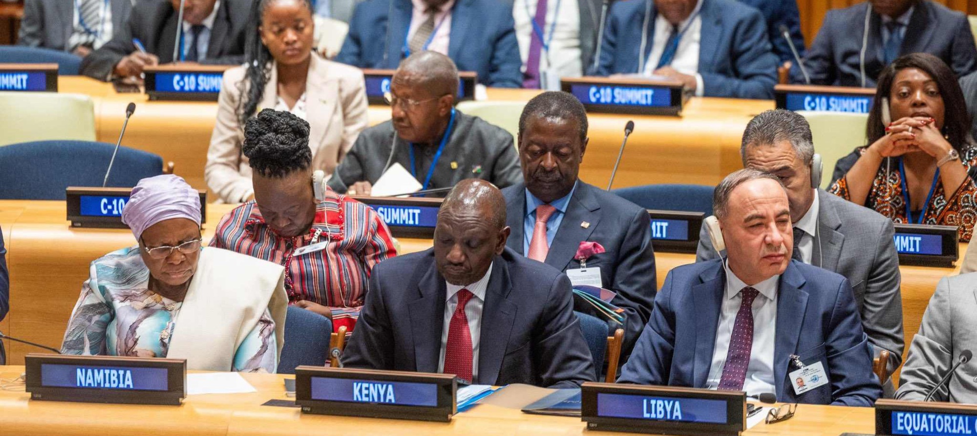 Delegates seated behind national nameplates at the United Nations